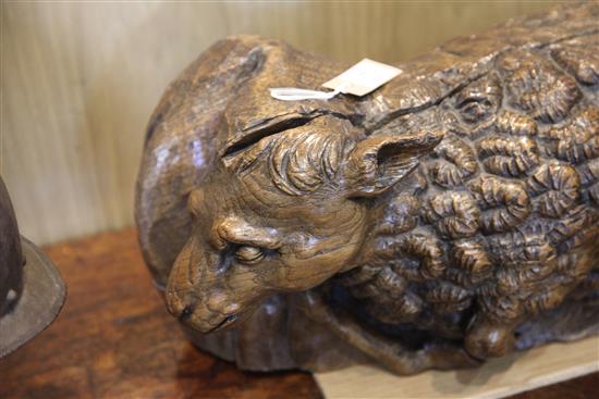 A 16th century Flemish oak deep relief figure of the recumbent lamb W.29in.